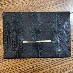 BCBG like new black leather snakeskin clutch